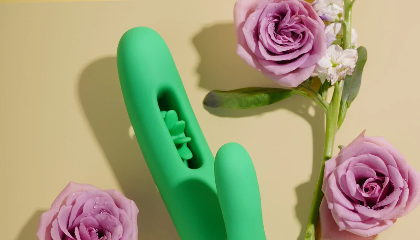 Green VINDANI Windmill rabbit vibrator with pink roses on a warm lifestyle background